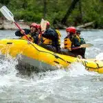 Family in splash gear on the french broad river rafting class II rapids
