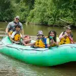 Group of people enjoying a tubing adventure on the French Broad River in Asheville